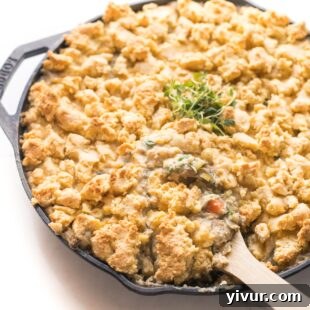 Keto chicken pot pie crumble in a cast iron skillet on a white background