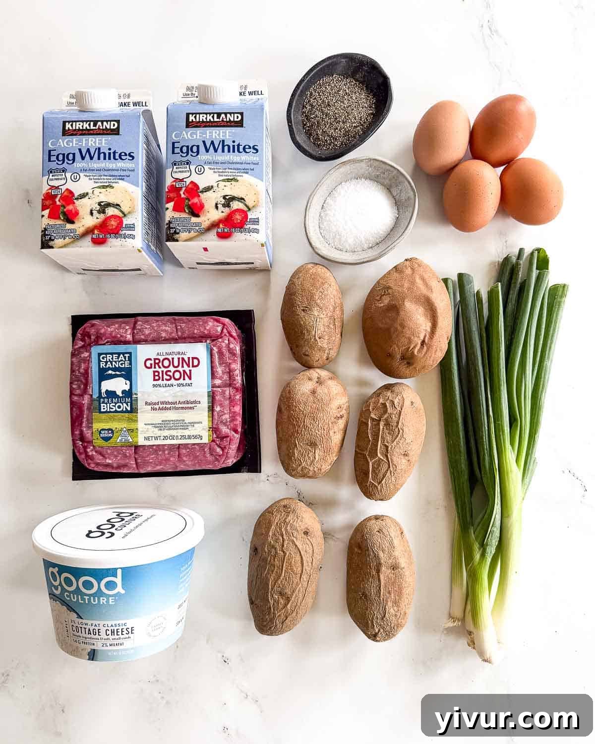 ingredients needed for High Protein Bison Breakfast Casserole with Potatoes and Eggs, including raw potatoes, ground bison, eggs, cottage cheese, and green onions