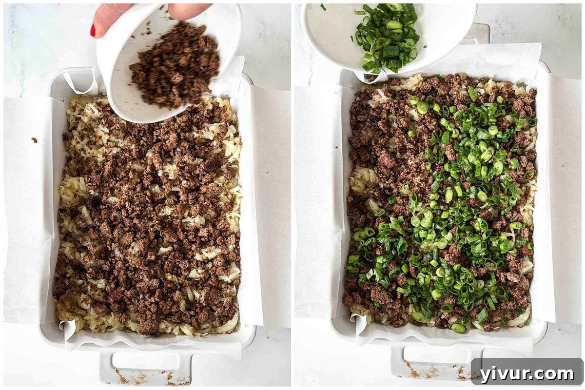Layering cooked ground bison and sliced green onions over the potato base for High Protein Bison Breakfast Casserole with Potatoes and Eggs