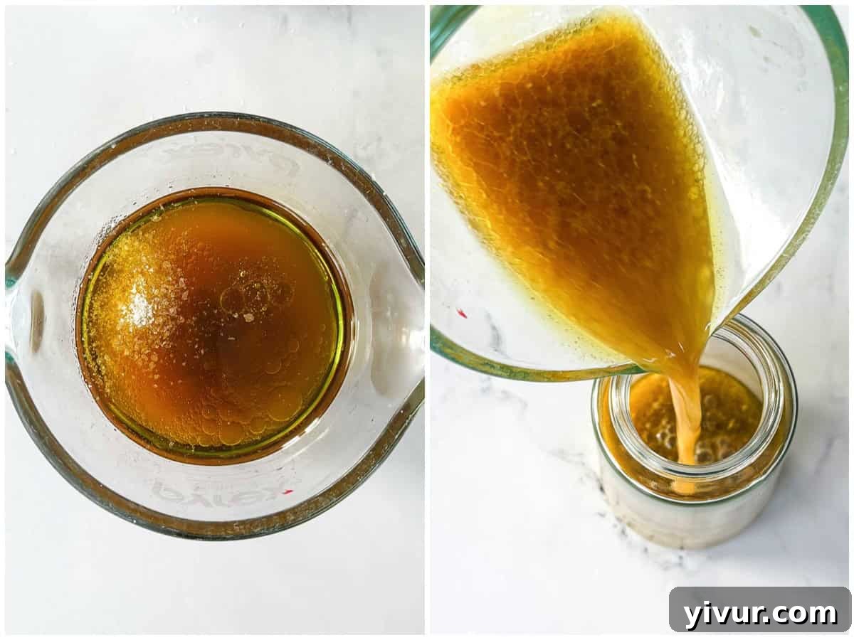 Ingredients for the apple cider vinaigrette, including olive oil, apple cider vinegar, dijon mustard, and honey, being whisked together in a bowl.