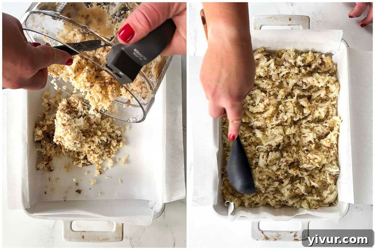 Shredded baked potatoes seasoned with salt in a baking dish