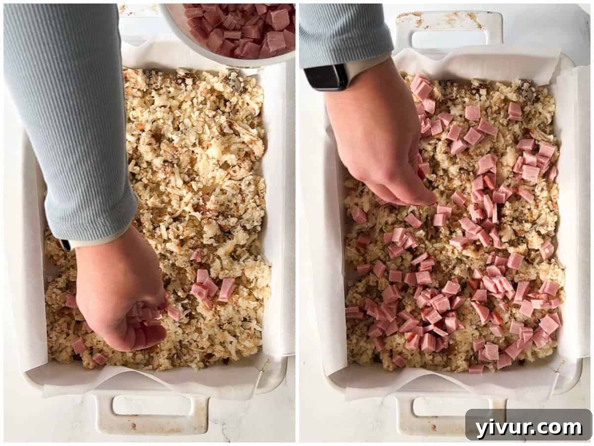 Chopped ham sprinkled over shredded potatoes in a baking dish