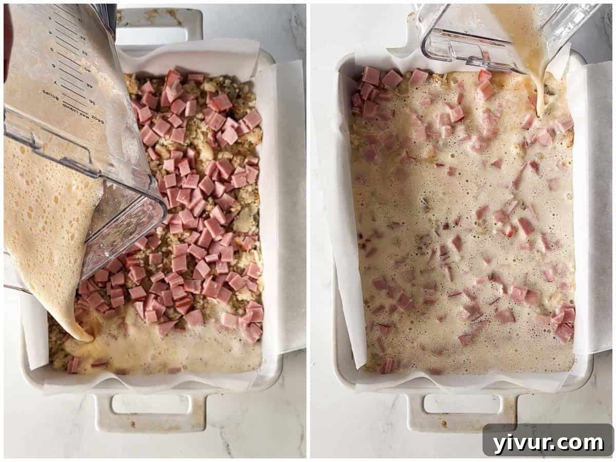 Egg mixture being poured over ham and potatoes in a baking dish