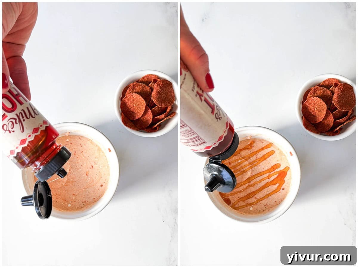 Drizzling on hot honey on the High Protein Pizza Dip with Cottage Cheese and Pepperoni