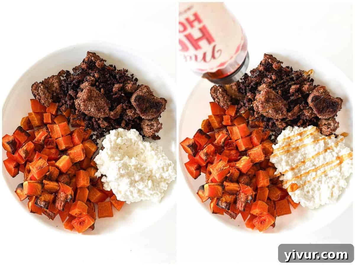 An assembled High Protein Bison Bowl featuring cooked bison, roasted butternut squash, a generous scoop of cottage cheese, and a drizzle of hot honey, ready to be served.