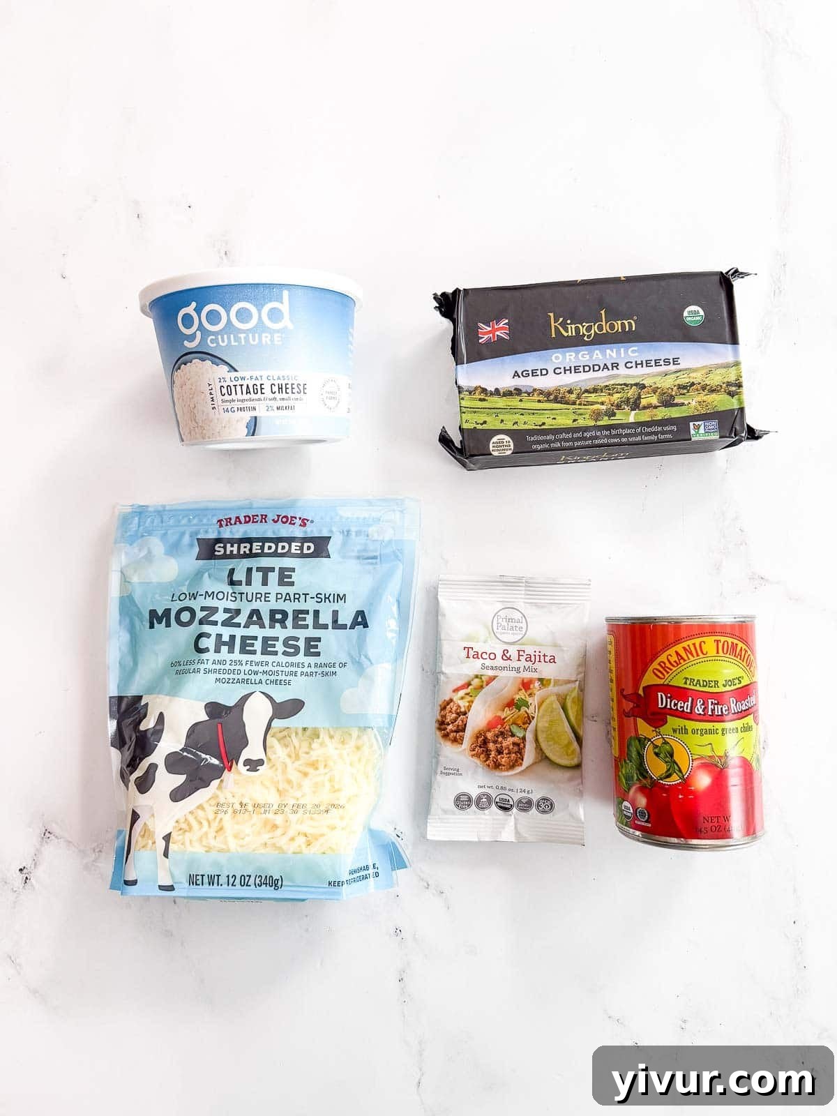 Protein-Boosted Cottage Cheese Queso 3 Ingredients for High Protein Queso Dip laid out on a wooden board: cottage cheese, shredded cheddar, mozzarella, taco seasoning, and canned fire-roasted tomatoes with green chiles.