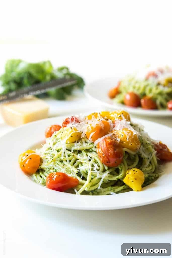 Fresh Kale Walnut Pesto Pasta with Blistered Tomatoes and Parmesan Cheese