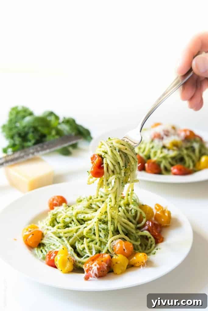 Close-up of a bowl of Kale Walnut Pesto Pasta with Blistered Tomatoes