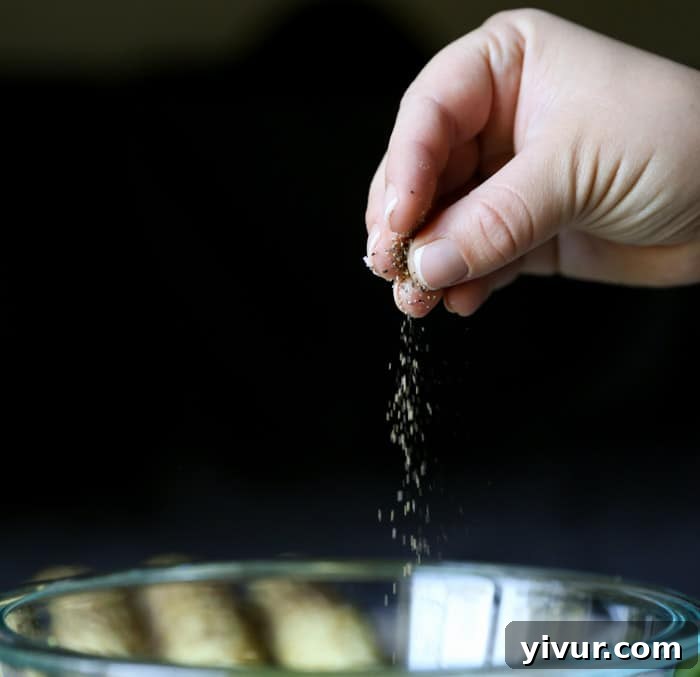 Finishing the dressing with freshly ground pepper