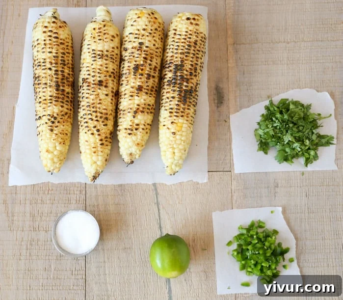 Fresh ingredients for Mexican Charred Corn Salad including corn, cilantro, and lime