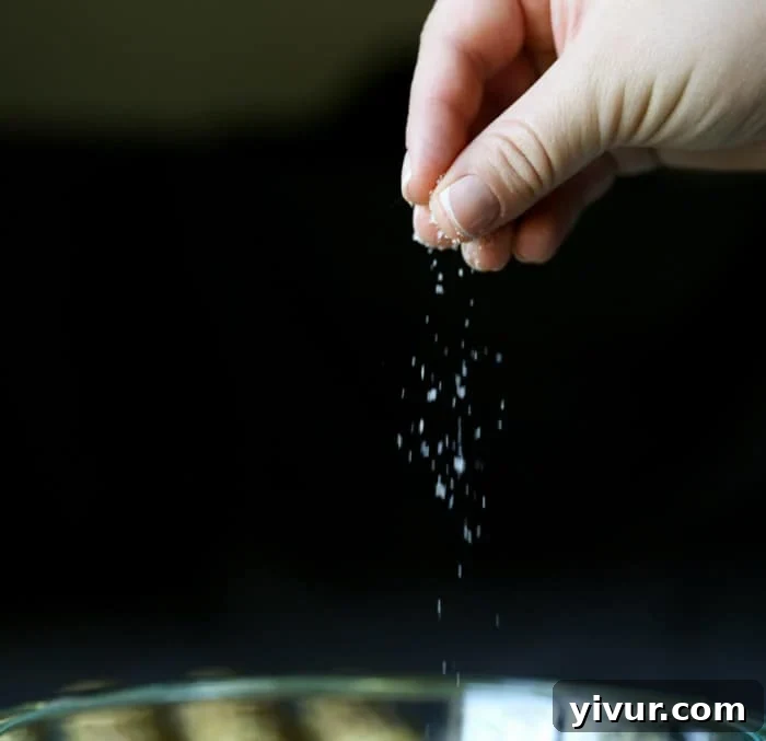 Seasoning the vinaigrette with a pinch of salt