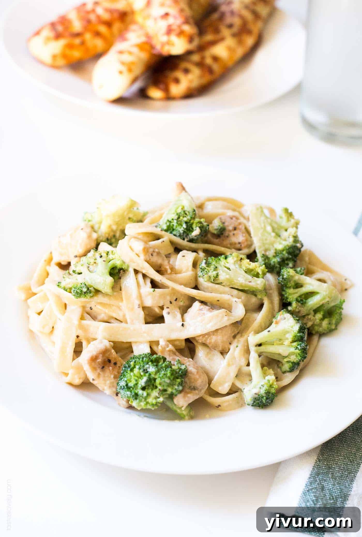 Quick Creamy Chicken Broccoli Fettuccine Alfredo 7 Broccoli chicken fettucine alfredo on a white plate
