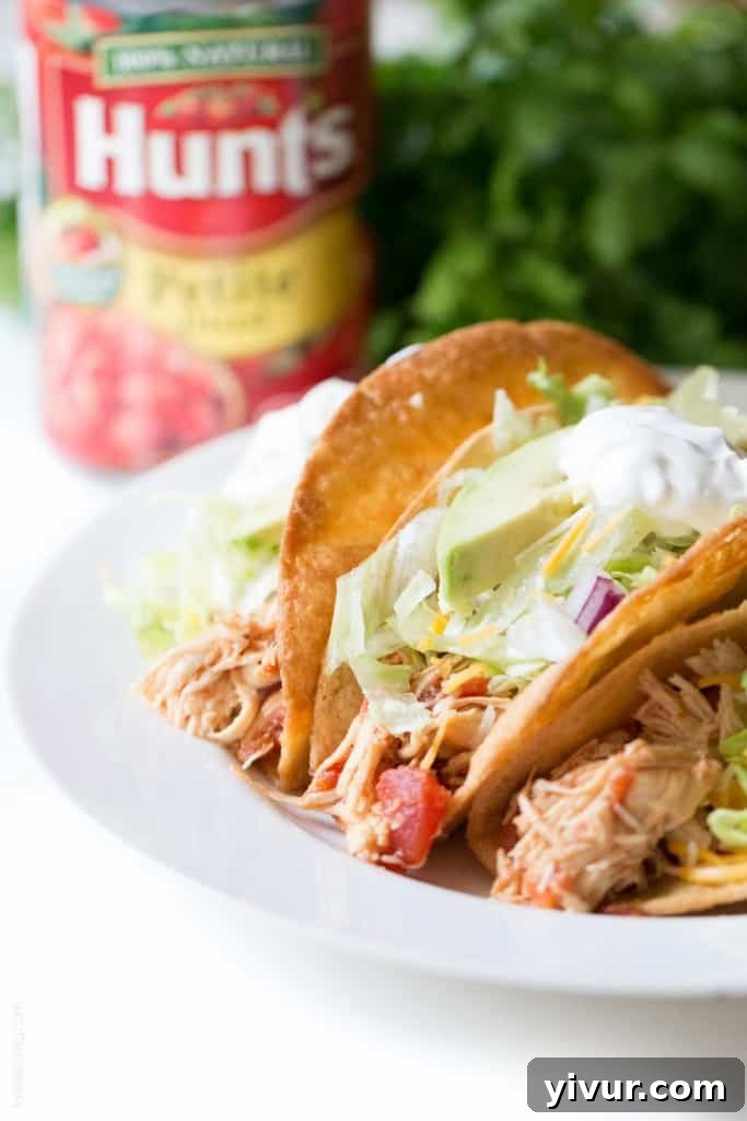 Overhead shot of Slow Cooker Mexican Shredded Chicken Tacos ingredients ready to be assembled, emphasizing fresh and healthy toppings.