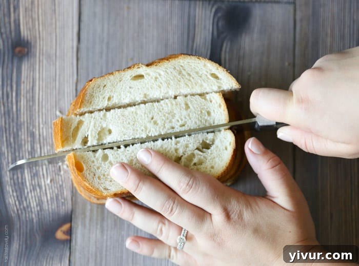 Crispy Garlic Parmesan Croutons 5 Sourdough bread slices being cut lengthwise into uniform strips on a wooden cutting board.