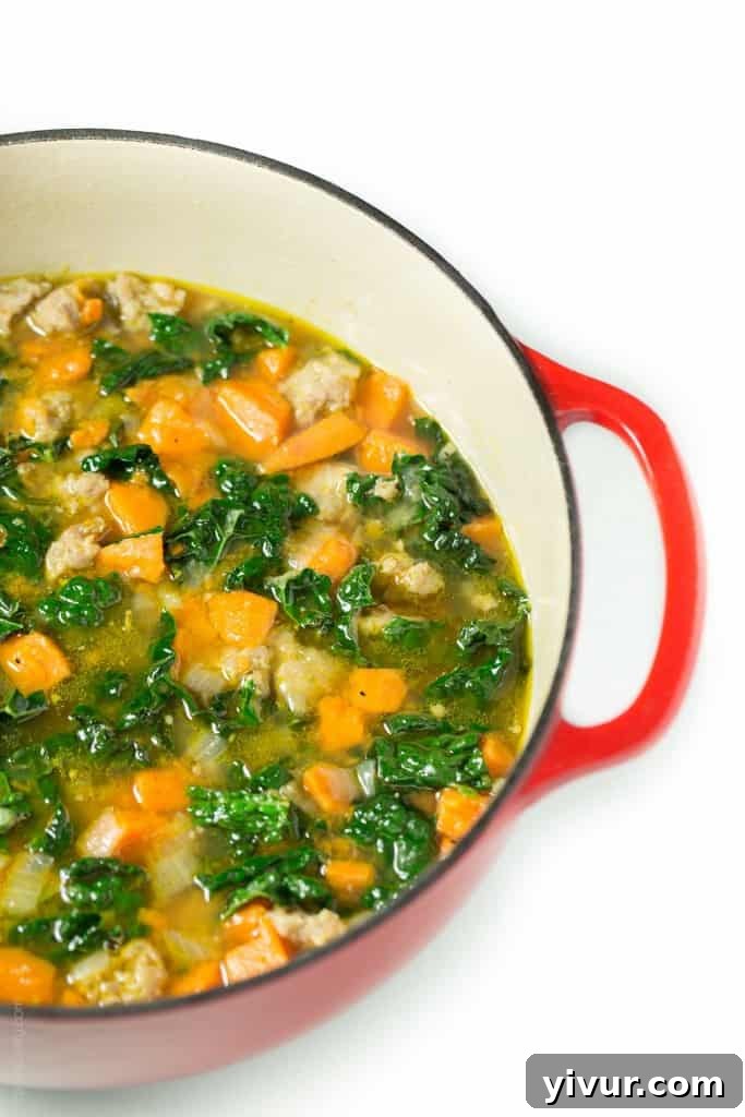 Delicious and Wholesome Italian Sausage and Sweet Potato Soup with fresh kale, served warm