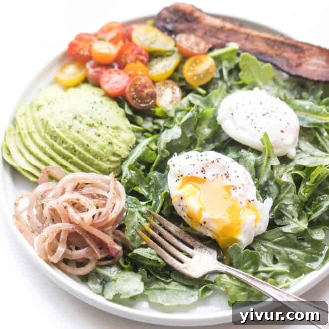 A fresh Keto Arugula Breakfast Salad with eggs and other healthy ingredients.