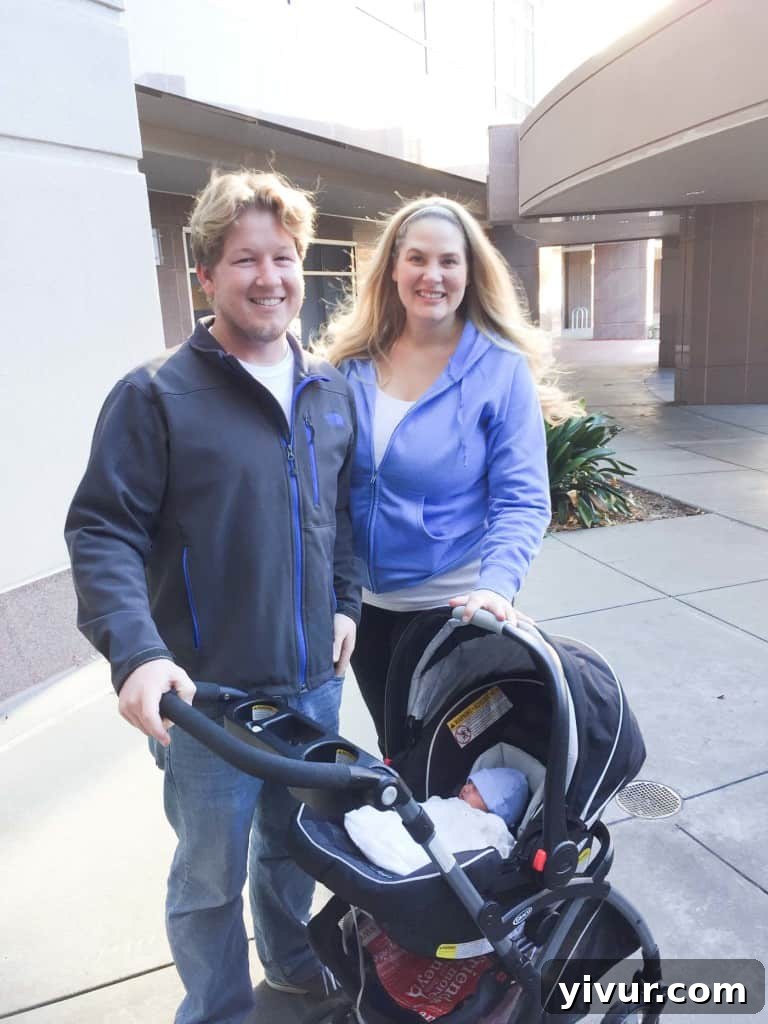 A family of three, parents holding their premature baby, leaving the hospital on Thanksgiving Day