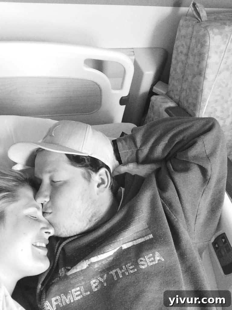 Pregnant couple cuddling in a hospital bed the night before their baby's birth