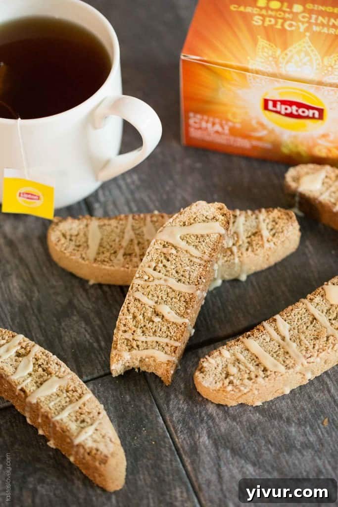 A plate of freshly baked Chai Spice Biscotti with a drizzle of sweet glaze.