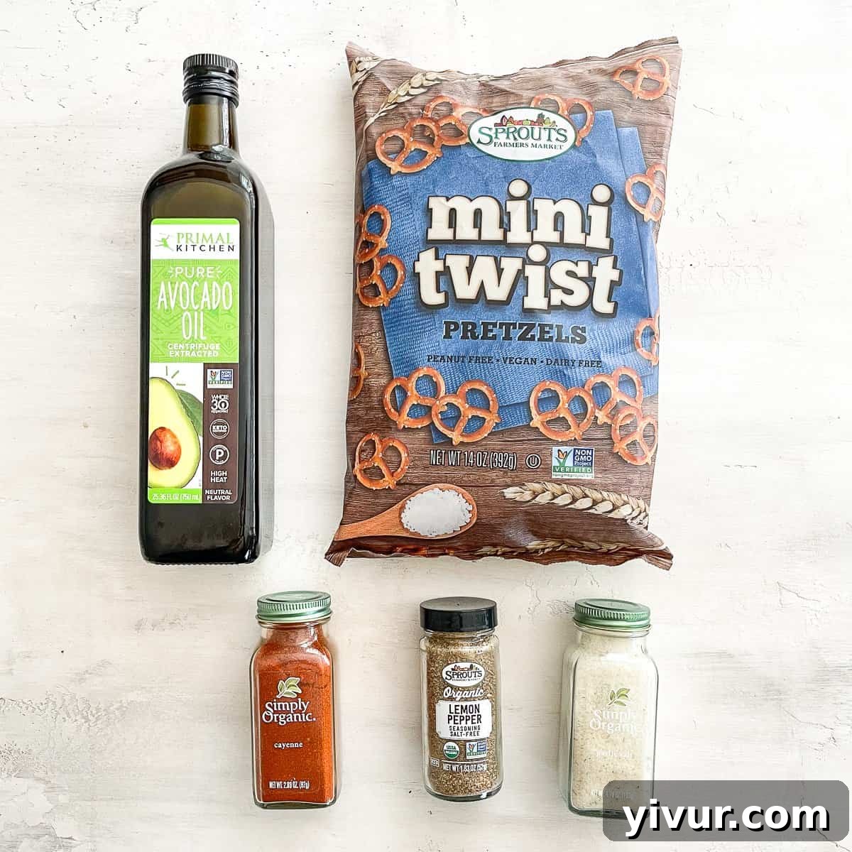 Effortless Fiery Pretzel Crunch 3 Avocado oil, pretzels, and spice ingredients laid out for preparation.