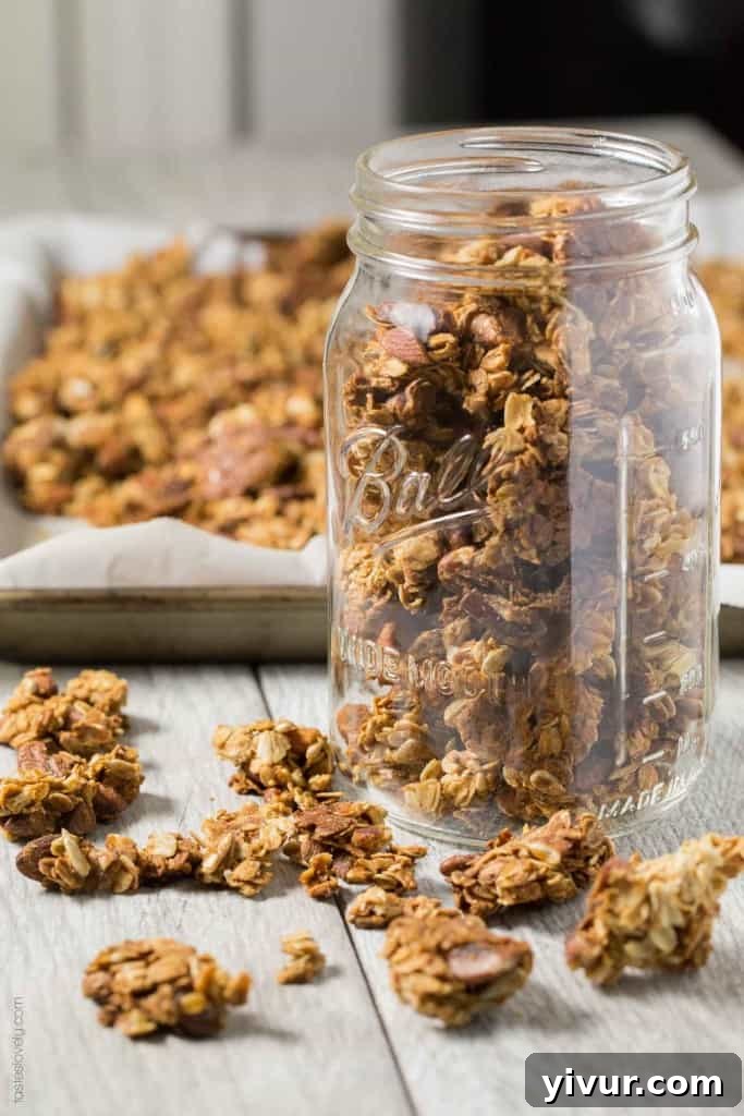 Nutty Coconut Oil Cluster Granola - Large, crunchy clusters of healthy homemade granola with various nuts, golden brown and inviting.