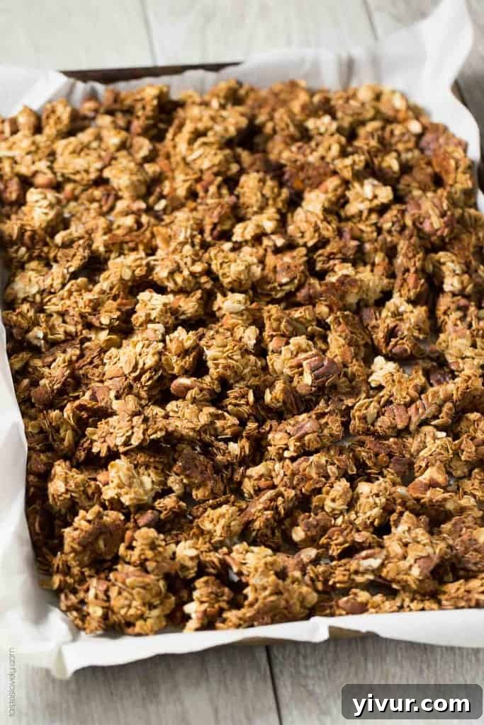 Nutty Coconut Oil Cluster Granola on a baking sheet, ready for baking, highlighting the wholesome ingredients.
