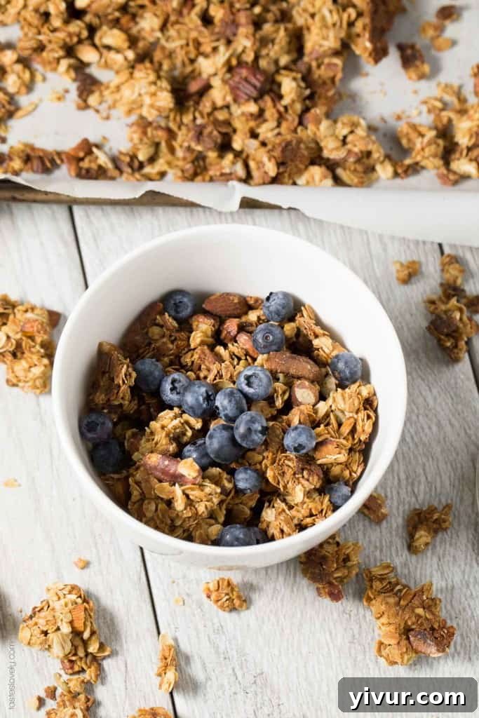 Close-up of baked Nutty Coconut Oil Cluster Granola, showcasing the golden-brown clusters.