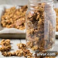 Nutty Coconut Oil Cluster Granola in a bowl with ingredients.