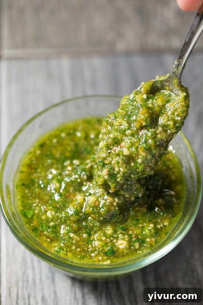 Sun-Kissed Pork Chops with Zesty Orange Parsley: Whole30 and Keto Perfect 5 Overhead view of a prepared meal featuring bone-in pork chops with orange parsley sauce, alongside healthy side dishes.