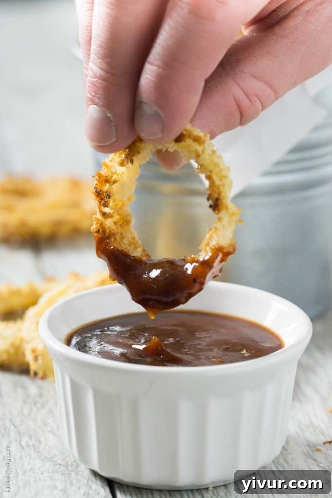Golden Rings of Oven-Baked Crunch 7 Crispy Oven Baked Onion Rings - Generous stack of onion rings on a wire rack