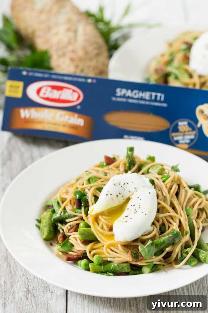 Spring Pasta with Bacon and Poached Egg served in a rustic bowl, showcasing the whole grain spaghetti.