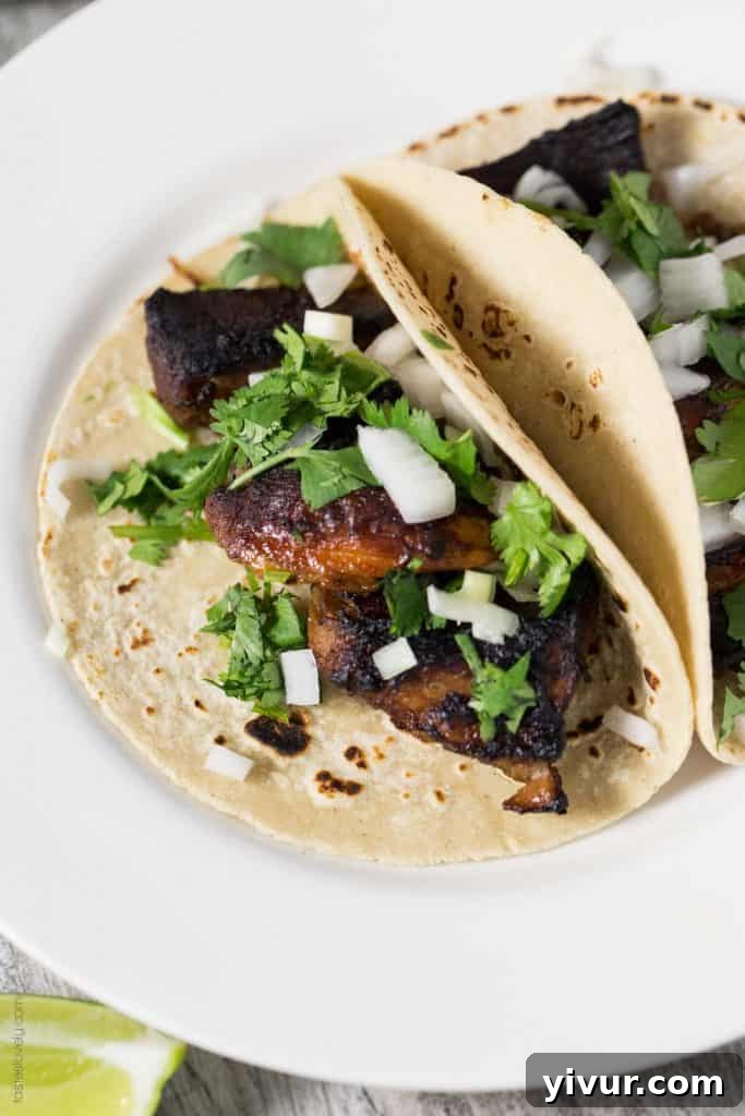 Tender and Crispy Carnitas Tacos ready to be assembled, showcasing the rich, broiled pork
