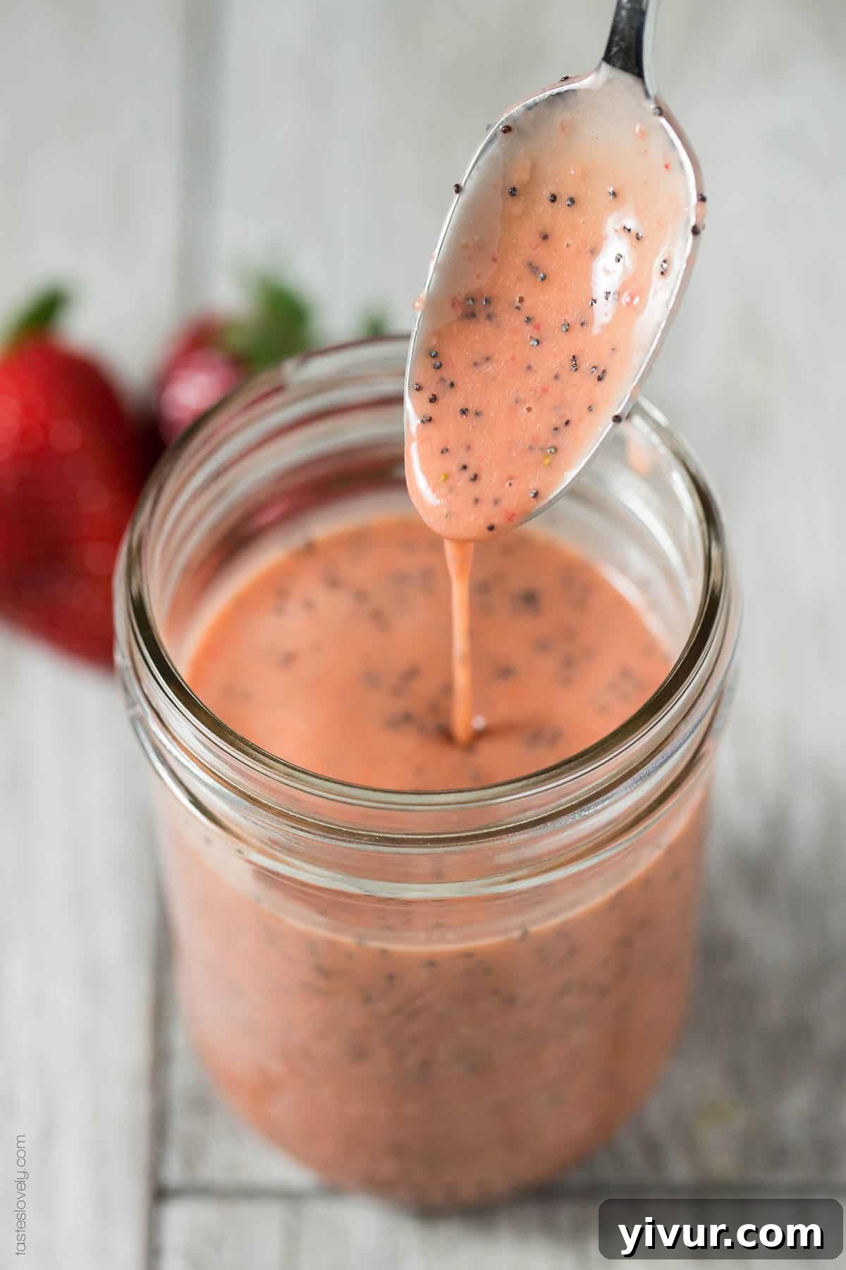 Vibrant Paleo Strawberry Poppyseed Dressing in a jar, ready to be enjoyed