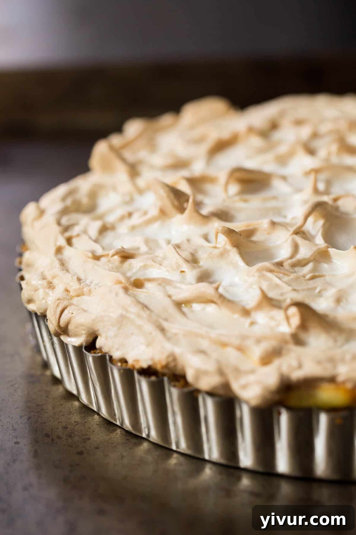 Full view of the dairy-free lemon meringue pie on a wooden surface