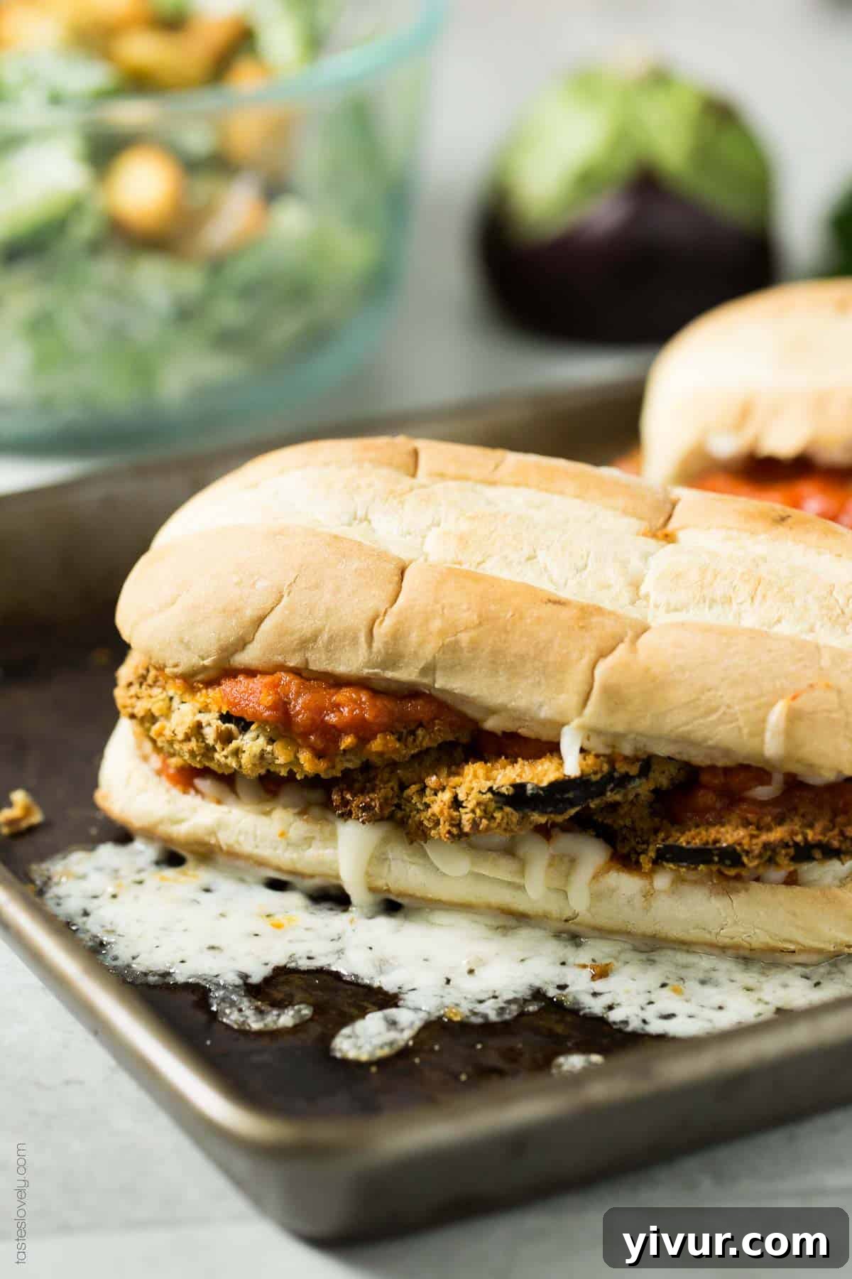 Delicious Vegan Crunchy Baked Eggplant Sandwich Melts on a baking sheet, ready for the oven.