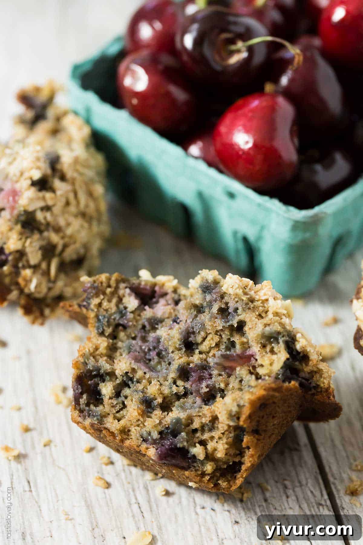 A tray of healthy cherry oatmeal muffins with streusel topping