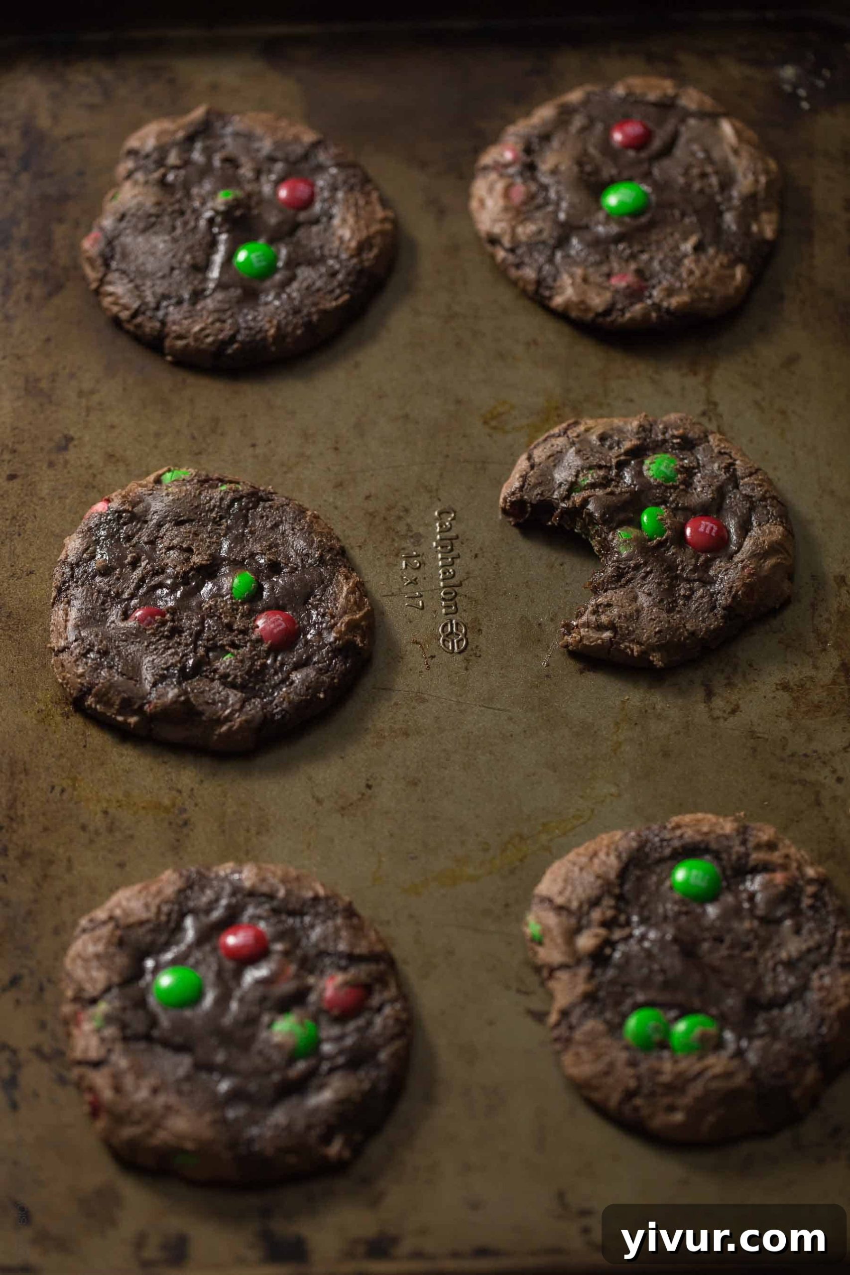 Freshly baked M&M’S® Brownie Mix Cookies cooling on a wire rack, showcasing their irresistible texture and colorful candy pieces.