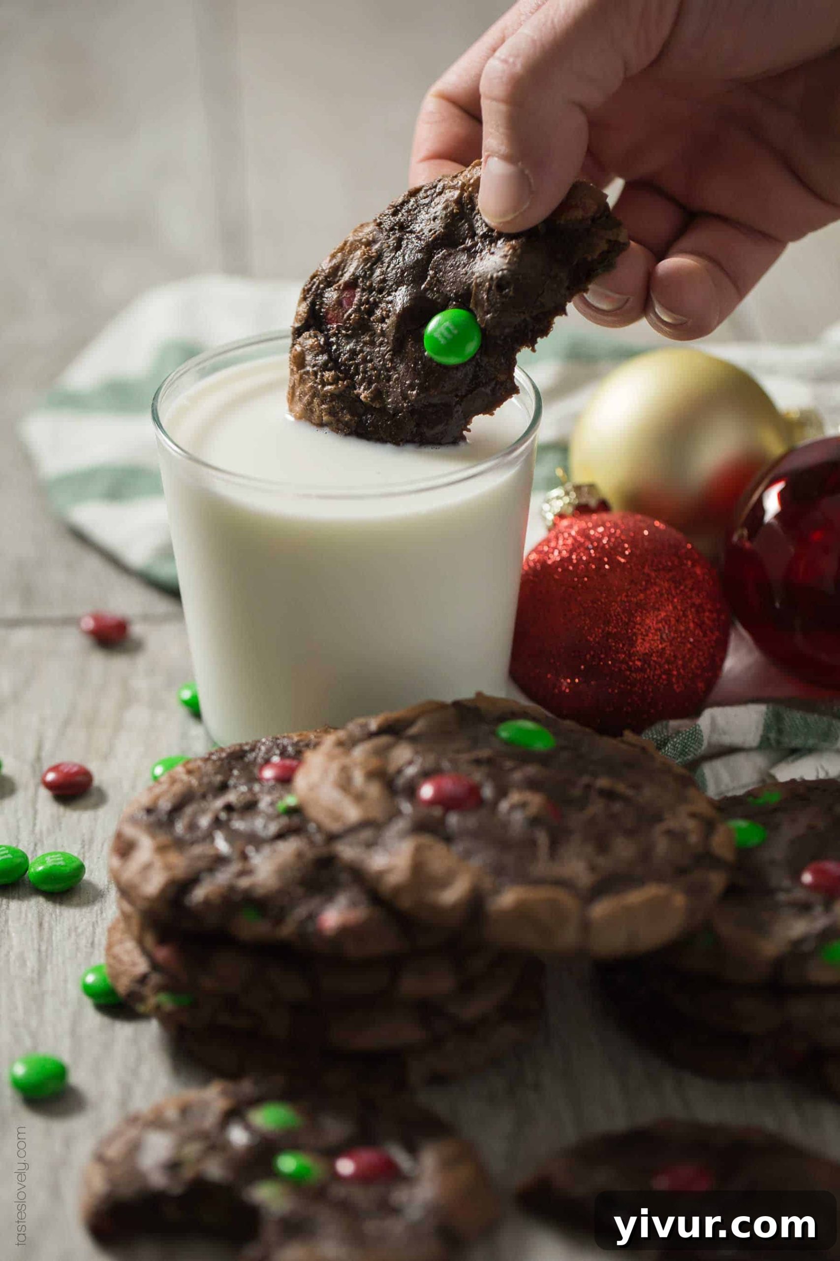 Close-up of a stack of M&M’S® Brownie Mix Cookies, highlighting the vibrant M&M's colors and the promise of a soft, chewy interior.