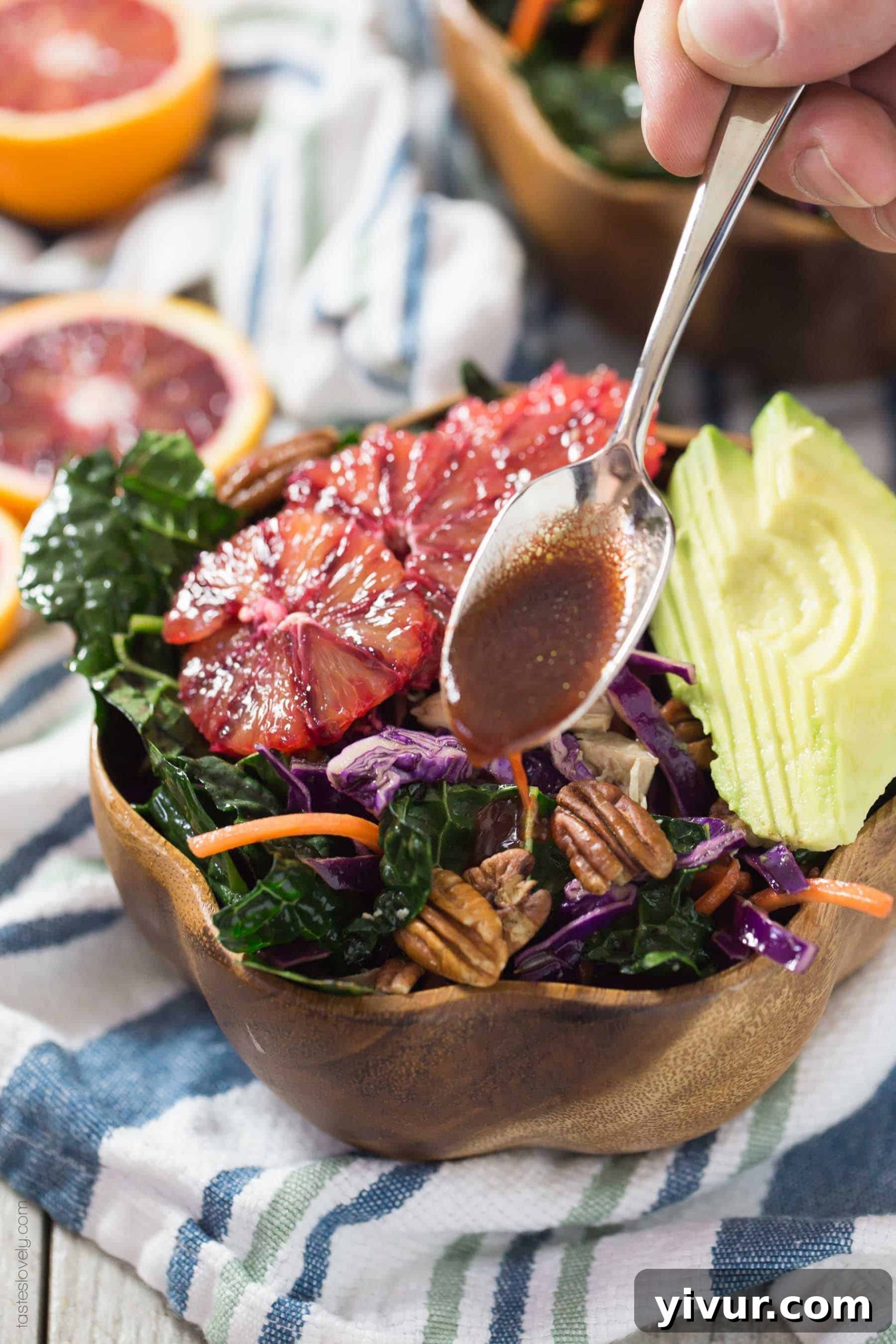Large bowl of Winter Kale and Blood Orange Salad with chicken and a blood orange balsamic vinaigrette