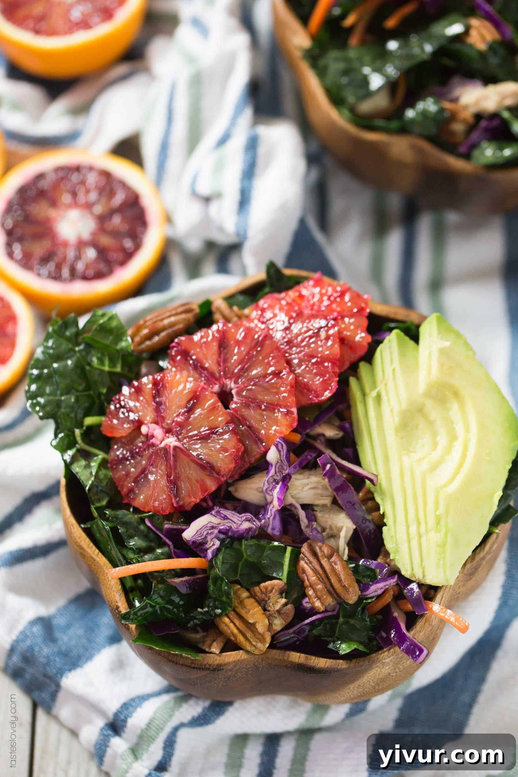 Bowl of Winter Kale and Blood Orange Salad with a side of homemade vinaigrette