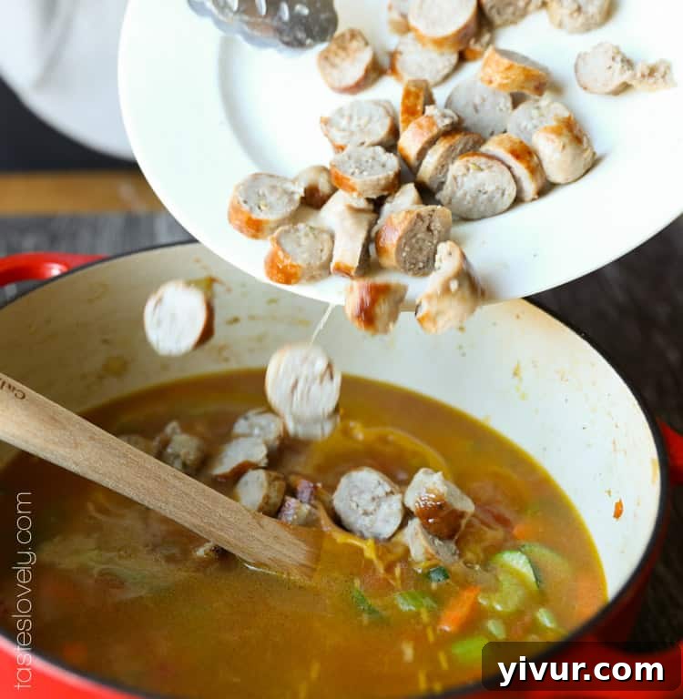 Sliced Italian sausage added to the vegetable and broth mixture