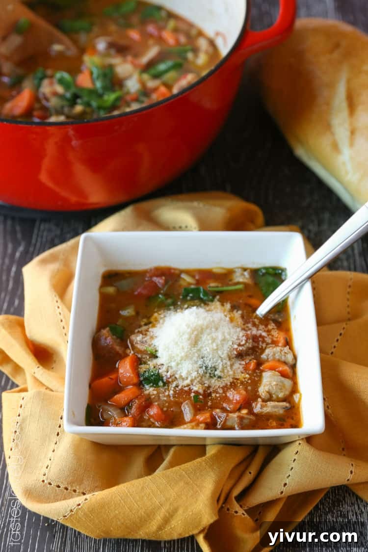 Italian Sausage and Vegetable Soup topped with grated Parmesan cheese
