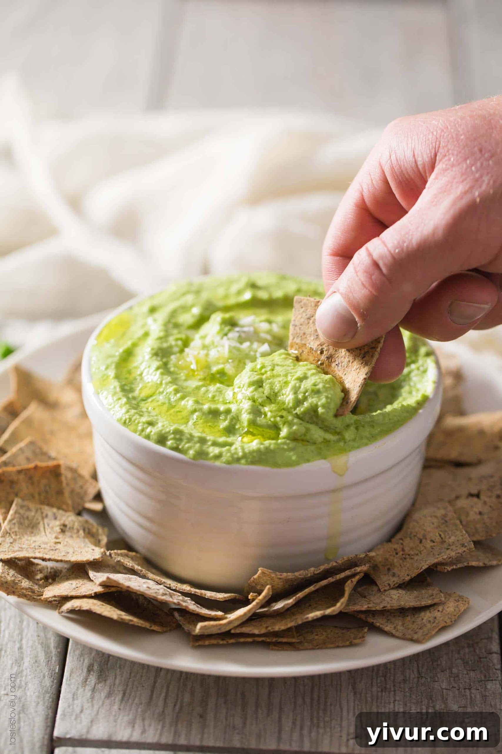 Paleo Sweet Pea No-Bean Hummus - a healthy spring appetizer served with paleo almond pulp crackers. Gluten-free, grain-free, dairy-free, sugar-free, and Whole30 compliant.