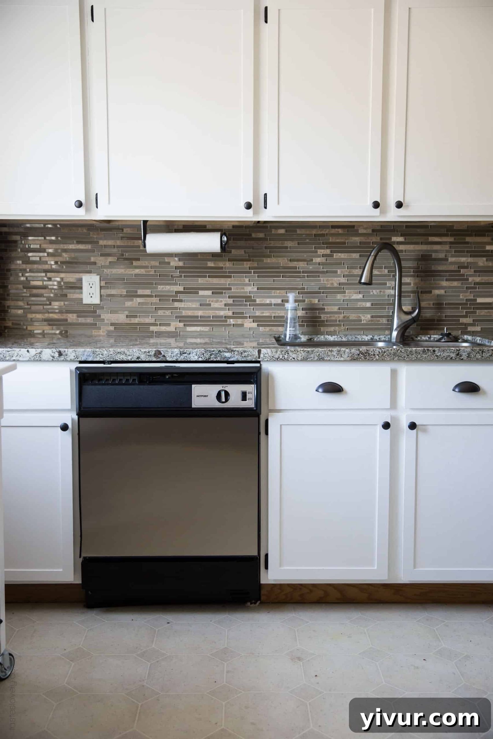Our $281 DIY Kitchen Remodel - DIY painting oak cabinets white, adding wood trim to make shaker style cabinets, and adding hardware