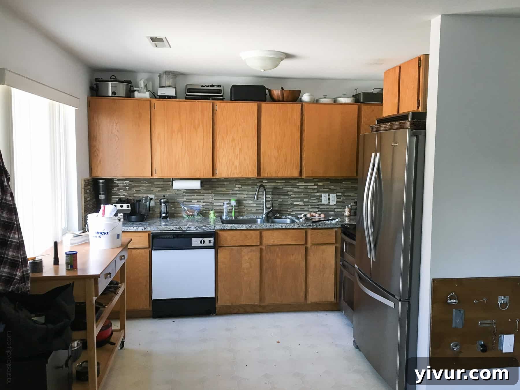 Before DIY kitchen remodel - flat door orangey oak cabinets and white dishwasher