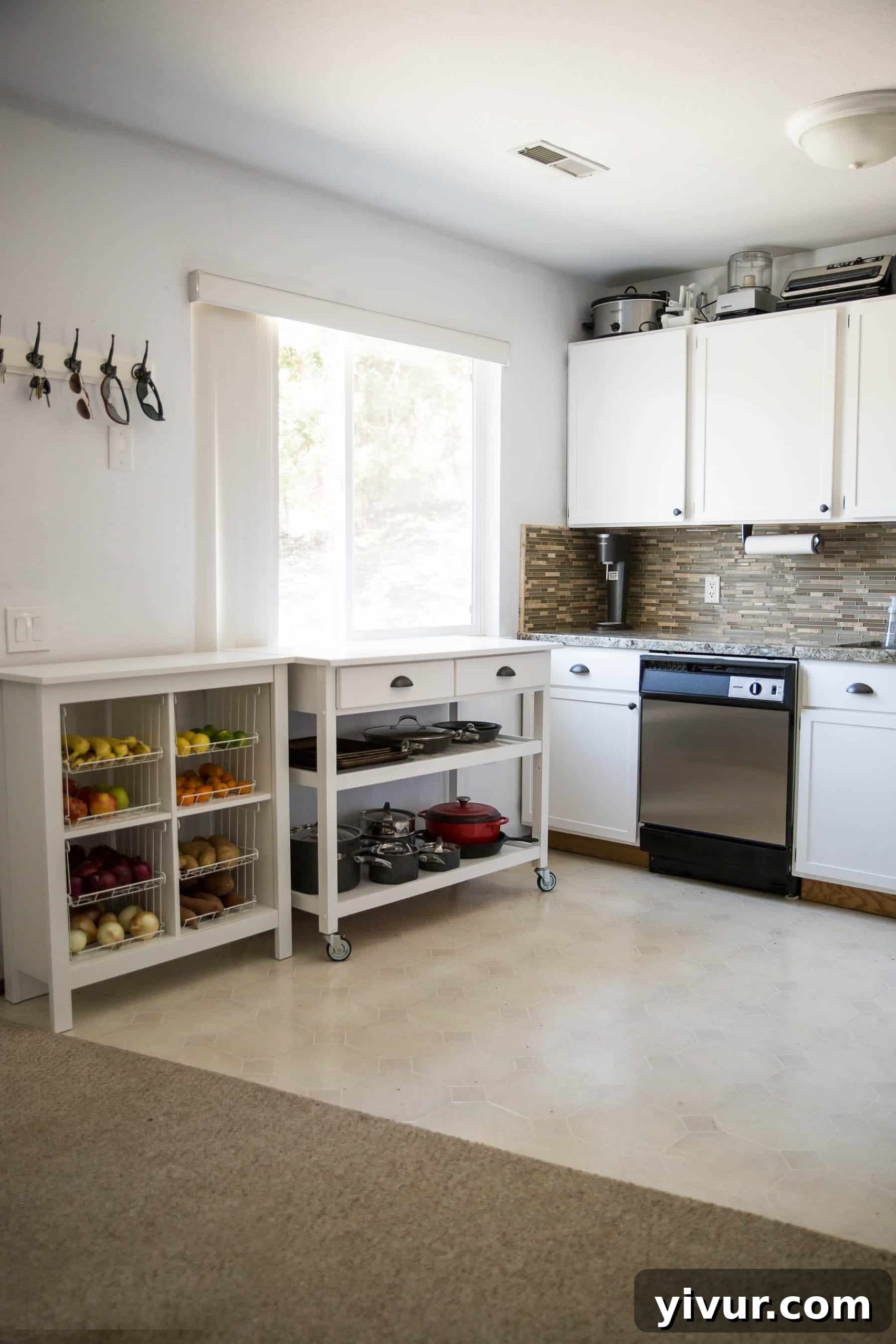 Bright and airy kitchen after DIY remodel, showcasing shaker cabinets and new hardware