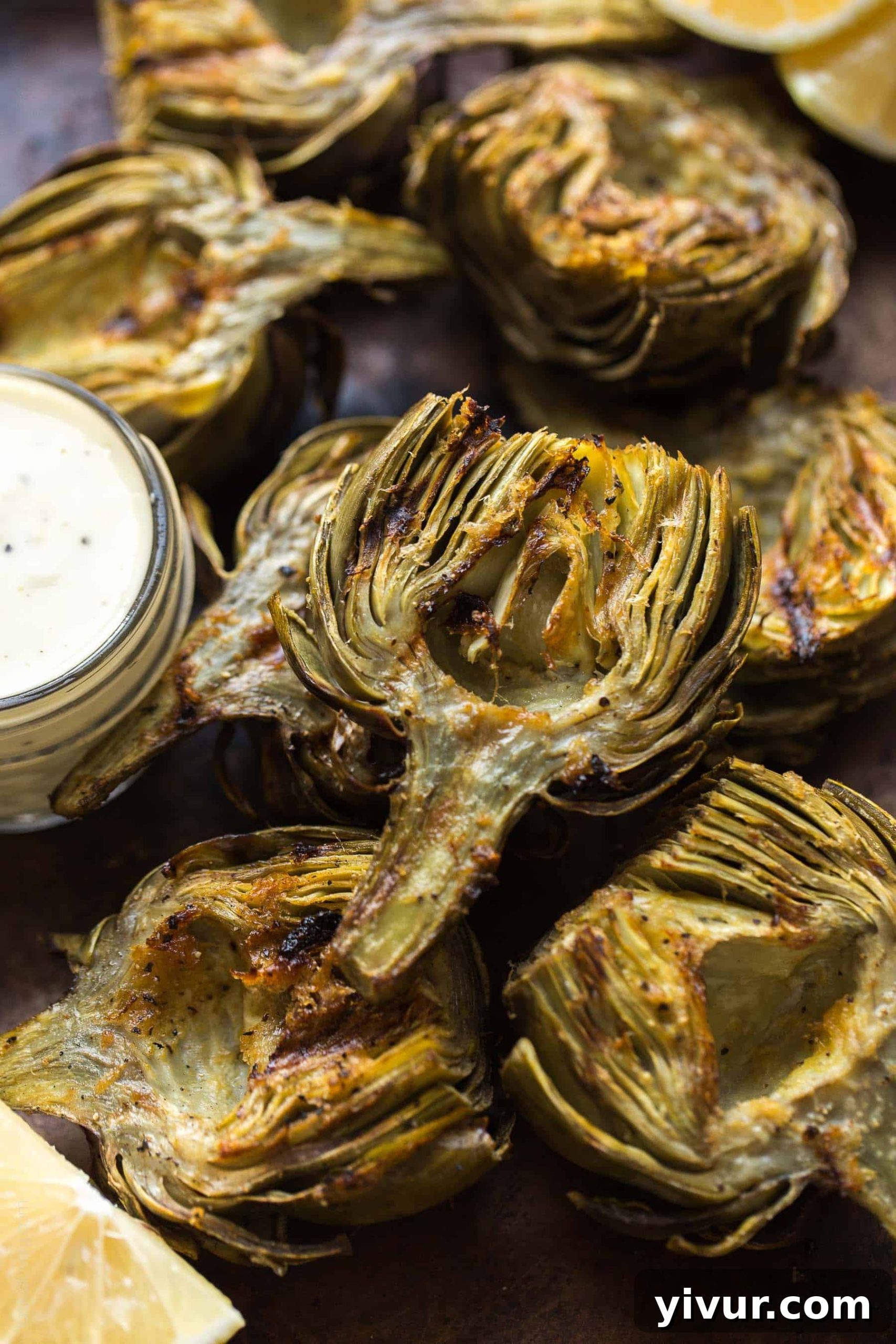 Paleo & Whole30 Grilled Artichokes with a lemon garlic basting oil and a lemon garlic aioli dipping sauce. A delicious appetizer or side dish recipe! Paleo, Whole30, gluten free, grain free, dairy free, sugar free, vegetarian, clean eating.