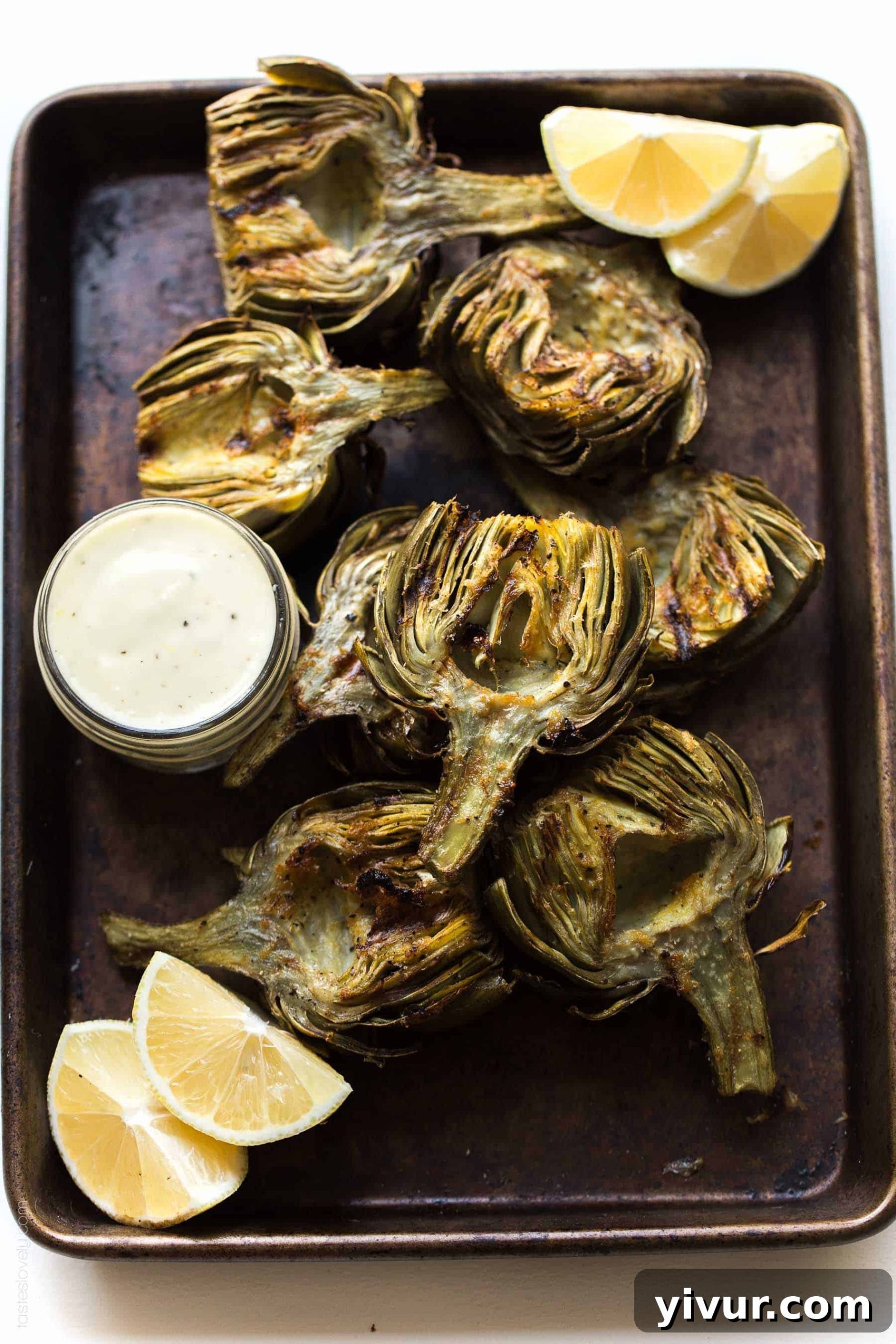 Close-up of freshly grilled artichoke halves showing crispy edges and tender insides, perfect for a Paleo and Whole30 diet.