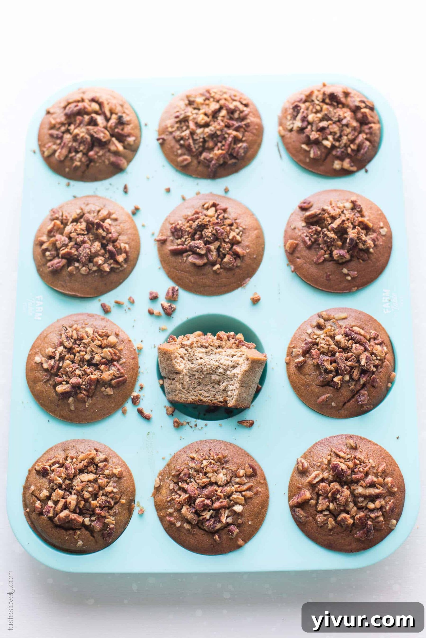 Freshly baked paleo banana muffins topped with chopped pecans, ready to be enjoyed.