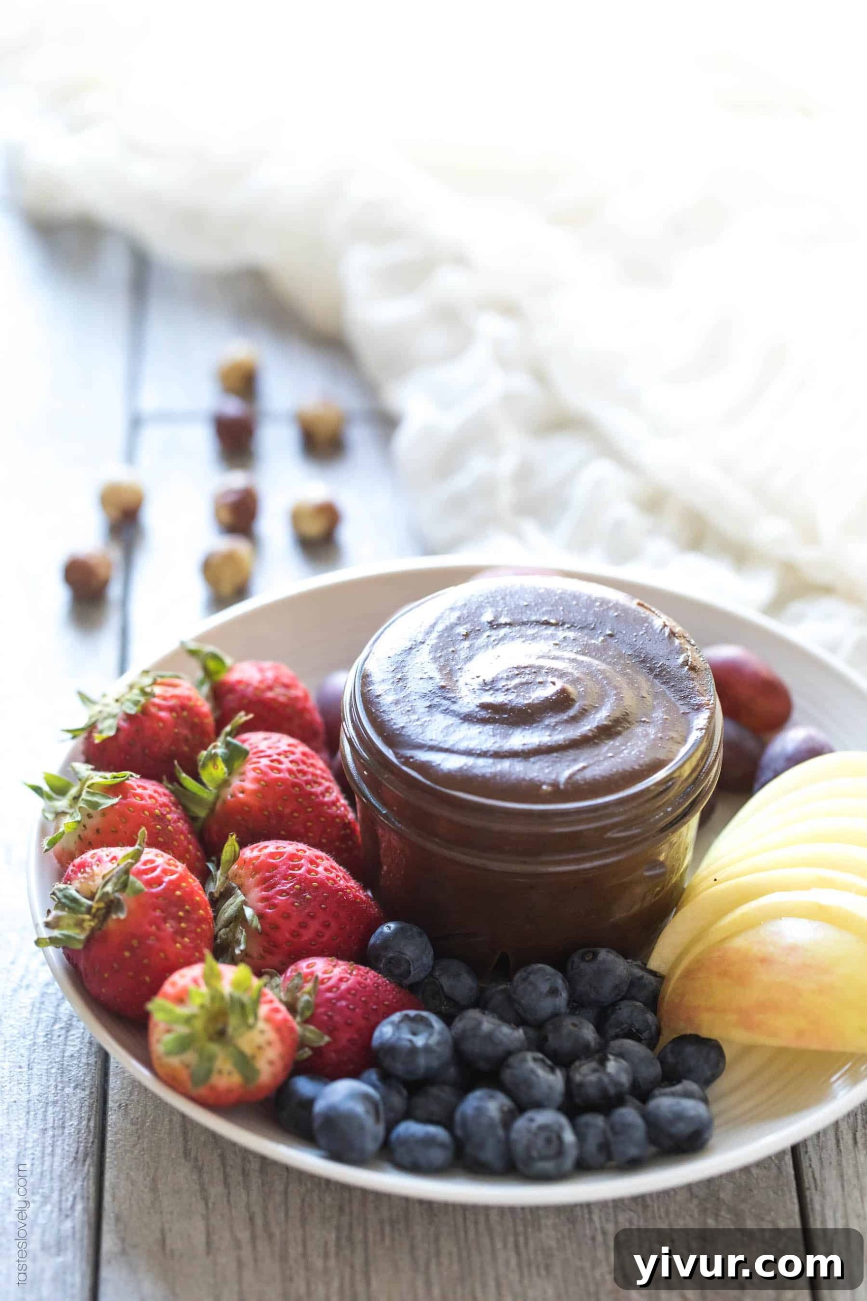 A spoonful of creamy homemade Paleo Nutella, perfect for dipping fruit.
